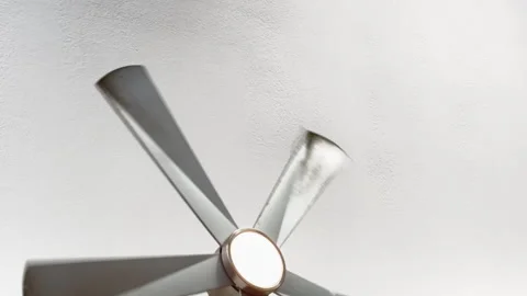 Modern ceiling fan rotates against plain white ceiling Stock Footage 344906128