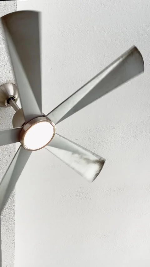 Modern ceiling fan rotates against plain white ceiling Stock Footage 344907390
