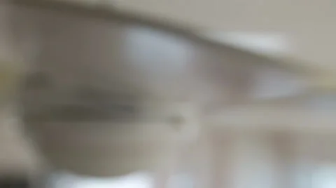 A modern ceiling fan spinning at the house rack focus Stock Footage 32886355