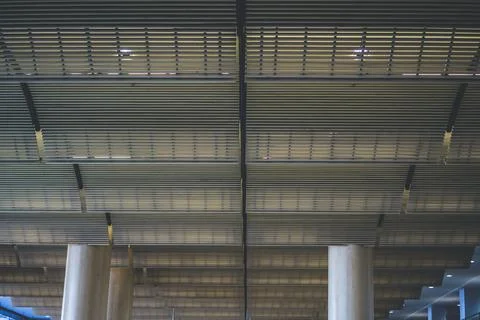 Modern ceiling with geometric lines in a row supported by architectural colum Stock Photos