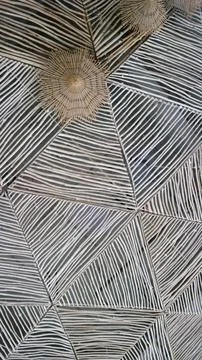 Modern ceiling with geometric pattern of thin gray wooden strips Stock Photos