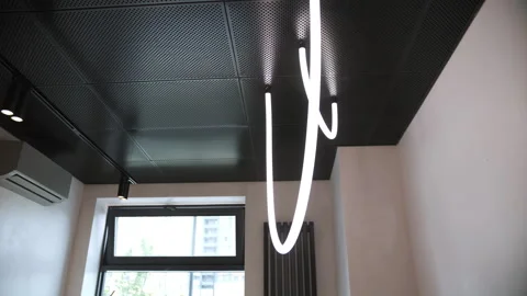 Modern ceiling with hanging LED ring light in apartment interior Stock Footage 311048529