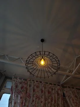 Modern ceiling lamp with geometric frame Stock Photos