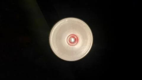 Modern ceiling light or light bulb hanging from ceiling in glass house constr Stock Photos