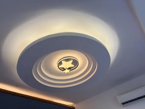 Modern Ceiling Light with Star Design and Soft Glow Stock Photos