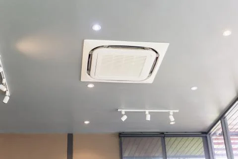 Modern ceiling mounted cassette type air conditioning system in coffee shop 写真素材