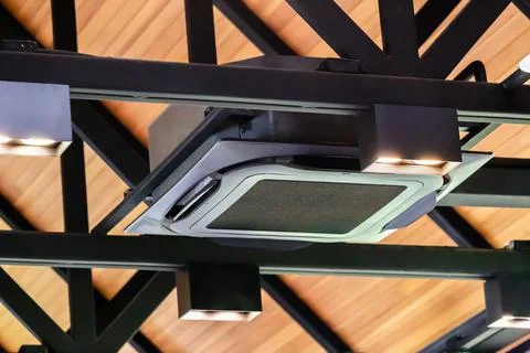 Modern ceiling mounted cassette type air conditioning system in coffee shop 库存照片