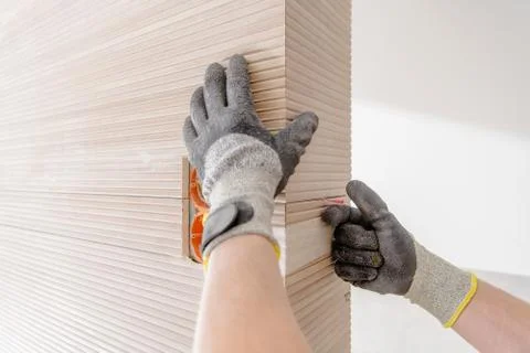 Modern Ceramic Tiles Installation Closeup Photo. Bathroom Remodeling Theme. Foto stock
