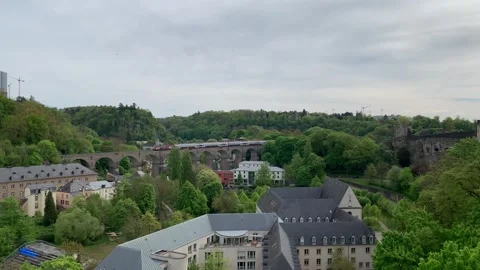 Modern CFL train crosses a bridge and enters a tunnel. Luxembourg City Stock Footage 308528905