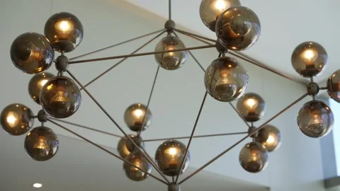 Modern chandelier with multiple spherical light bulbs connected by metal rods Stock-Footage 295551425