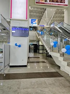 Modern check in counters and spacious terminal interior at Madurai Airport. Stock Photos