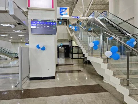 Modern check in counters and spacious terminal interior at Madurai Airport. Stock Photos