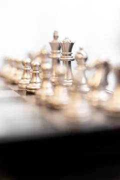 Modern chessboard on a black table Stock Photos
