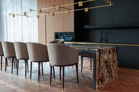 Modern chic kitchen with a stylish stone table. Stock Photos