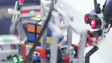 Modern children with the color sensor robot collects Rubiks Cube Stock Footage 81787574