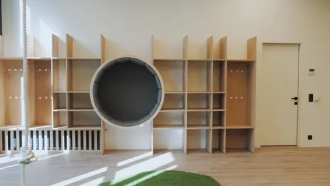A Modern Childrens Playroom with Functional Storage, Cozy Elements, and Bright Video stock 287613228