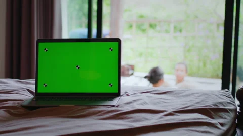 Modern chroma key green screen laptop computer on the bed Видео 341915630
