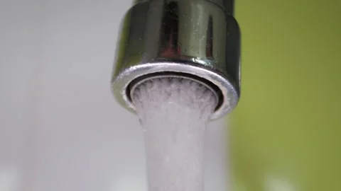 Modern Chrome Tap Pouring Clear Aerated Water Inside Clean Kitchen Sink Video stock 339216343