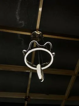 Modern Circular LED Pendant Light Hanging in a Dark Room Stock Photos