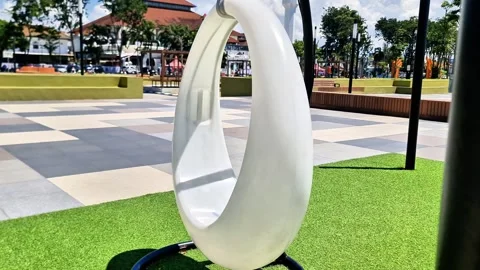 Modern Circular Swing in City Square Playground with Urban Landscape Video stock 332156205