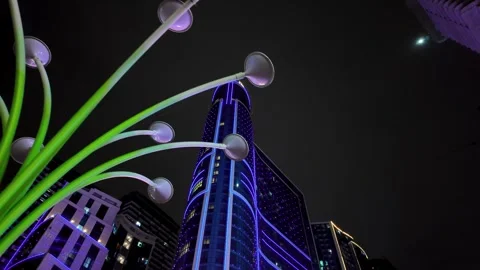 Modern city skyscraper changing neon light colors at night Видео 337889829