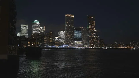 A modern city view across a river at night. Video stock 167895657