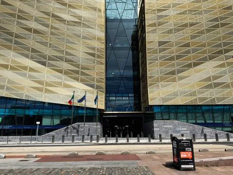 Modern civic building facade with flags and glass entrance in Dublin, Irela.. Stock Photos