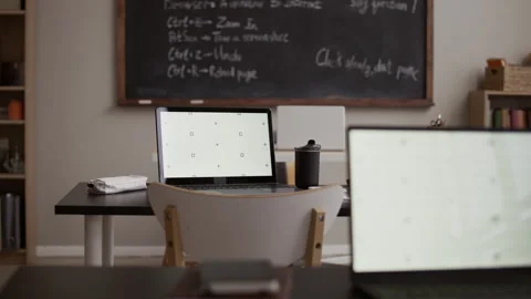 Modern Classroom Workspace with Laptops and Chalkboard Stock Footage 329283802