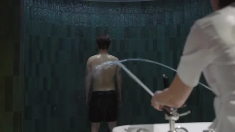In modern clinic shot back man enjoys anti-cellulite treatment experiencing Stock Footage 207064034