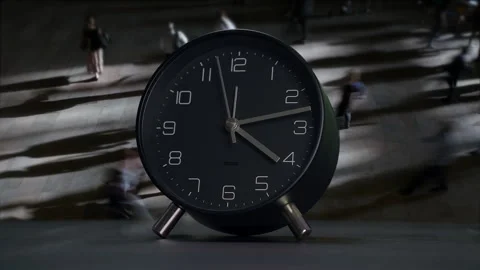 A modern clock design featuring a dynamic background with people in motion Stock Footage 292516861