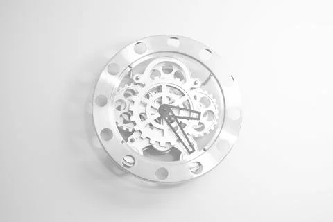 A modern clock hanging on the wall made of metal wheels 写真素材