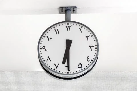 Modern clock round shape with Arabic circulars on dial and hands. Stock Photos