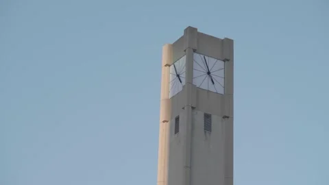 Modern Clock Tower Against a Clear Blue Sky Video stock 332689010