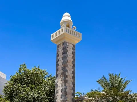 Modern Clock Tower Against Clear Blue Sky in Urban Park Setting Stock Photos