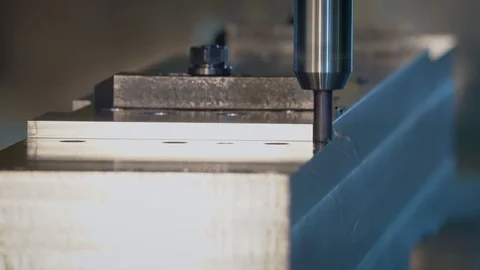 A modern CNC milling machine cutting metal in a machine shop. Stock Footage 111006466