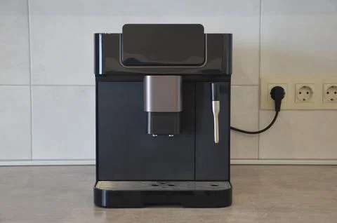 A modern coffee machine on a gray marble countertop in the kitchen. Home ap.. 스톡 사진