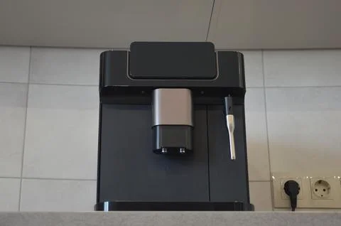 A modern coffee machine on a gray marble countertop in the kitchen. Home ap.. Stock Photos