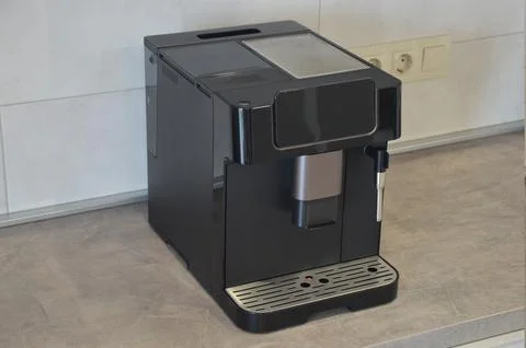 A modern coffee machine on a gray marble countertop in the kitchen. Home ap.. Stock Photos