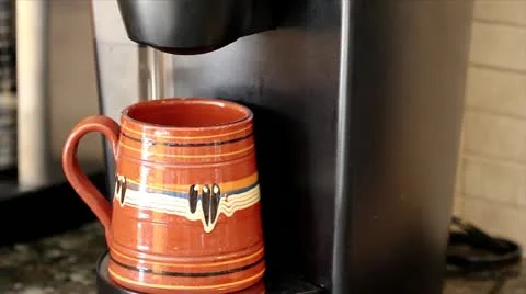 A Modern Coffee Maker Brews into a Single Cup (coffee seen streaming into mug) Stock Footage 10947262