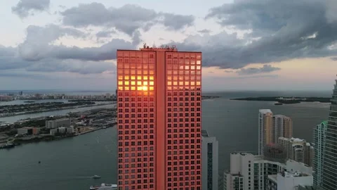 Modern colored skyscraper with beautiful sunset reflection on glossy exterior Stock Footage 254438550