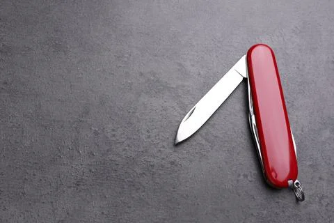 Modern compact portable multitool on grey table, top view. Space for text Stock Photos