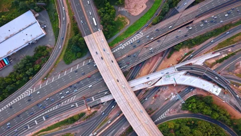 Modern complex interchange with fast running cars. Drone flight over the Stock Footage 342454071
