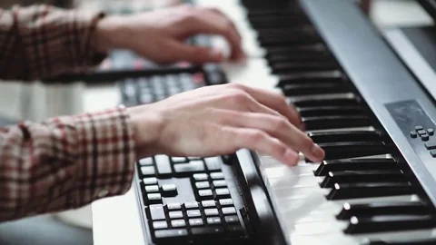 Modern composer writes music, playing on an electronic synthesizer Stock Footage 84969208