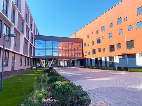Modern comprehensive school building with large glass entrance and colorful Stock Photos