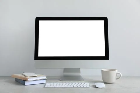 Modern computer with blank screen on light grey table. Mockup for design Stock Photos