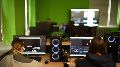 Modern computer classroom with multiple workstations, screens and students Stock Footage 332736668