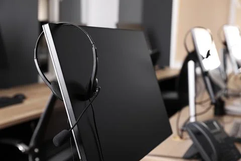 Modern computer with headset in office. Hotline service Stock Photos