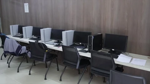 Modern Computer Lab Interior with Rows of Desktop PCs and Ergonomic Chairs Stock Footage 334492588