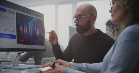 In Modern Computer Lab, Young Teacher Demonstrates Adult Student How Write Stock Footage 321254390