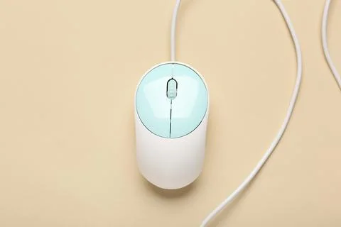 Modern computer mouse on beige background Stock Photos